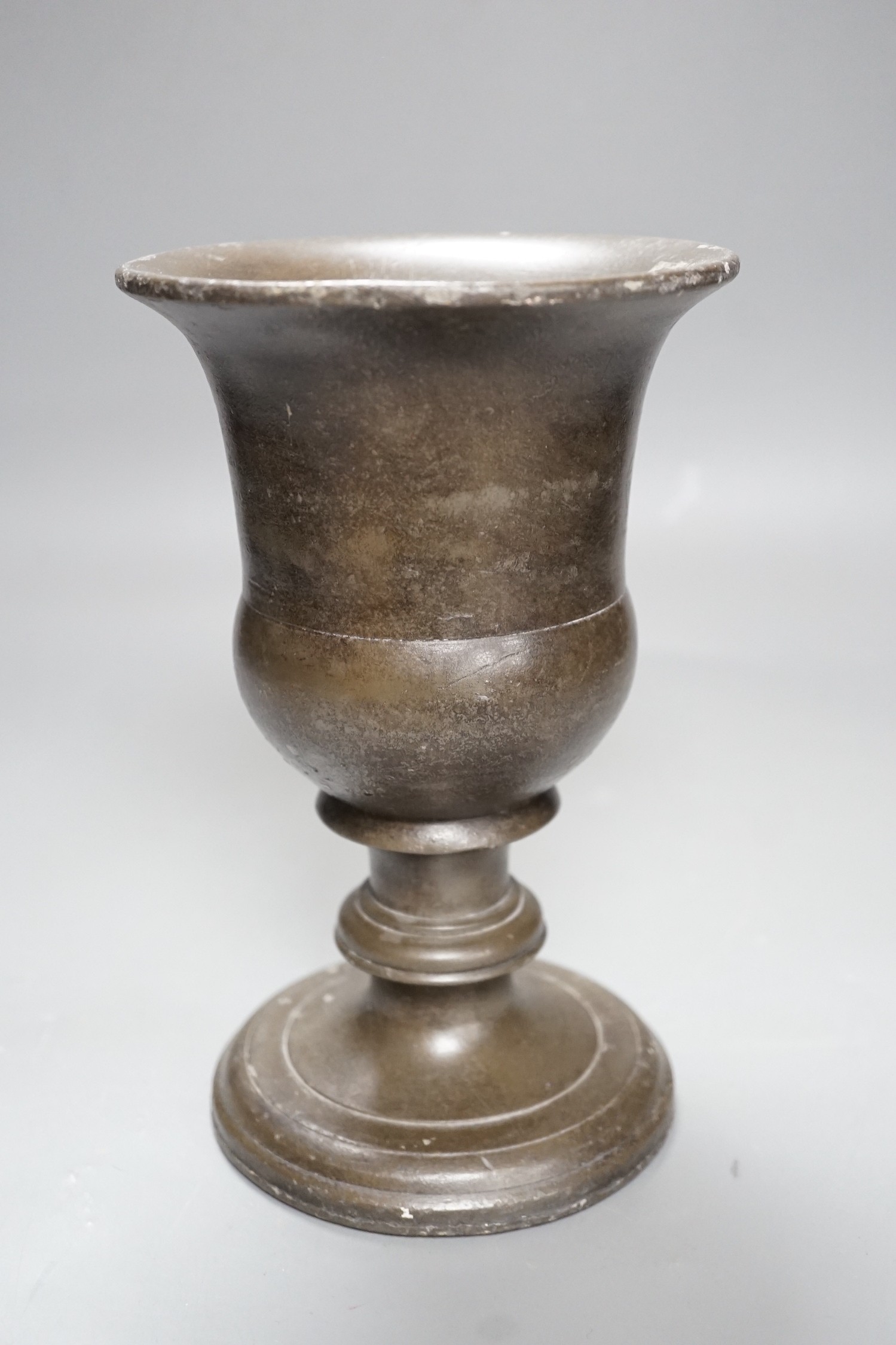 A bronzed cast iron urn, 22cm